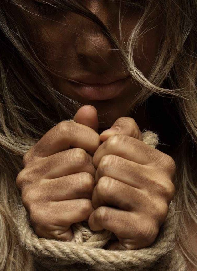close up photo of woman with her hands tied with rope